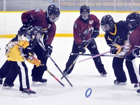 Courtney Paulen (76) and Alyssa McCarthy of the Mitchell U16 ringette team battle these three Seaforth opponents during WRRL action in Mitchell March 2, a 2-1 win for the Stingers. ANDY BADER/MITCHELL ADVOCATE