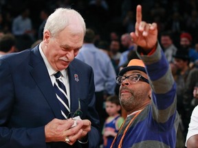Former Los Angeles Lakers coach Phil Jackson (L) waits with film director Spike Lee before the New York Knicks honoured their 1972 NBA Championship team last year. (REUTERS)