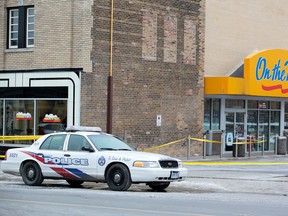 Police tape cordons off an Esso on the Run station at Greenwood and Danforth. (JOHN HANLEY/Special to the Toronto Sun)