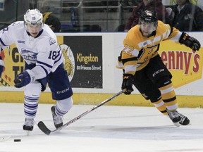 Kingston Frontenacs forward Darcy Greenaway tries to get the puck from the Misssissauga Steelheads’ Sam Babintsev during Ontario Hockey League action at the Rogers K-Rock Centre on Sunday. Kingston’s 5-3 win, coupled with Barrie’s loss to Niagara, guaranteed the Frontenacs home-ice advantage for the first round of the playoffs. (Julia McKay/The Whig-Standard)