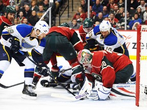 Minnesota Wild goalie Ilya Bryzgalov covers the puck in front of of St. Louis Blues forward Steve Ott at the Xcel Energy Center in St. Paul, Minn., March 9, 2014. (MARILYN INDAHL/USA Today)