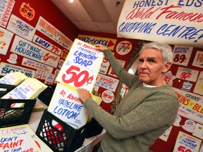 Honest Ed's sign painter Douglas Kerr holds up some of his work on Monday March 10, 2014. (Dave Thomas/Toronto Sun)