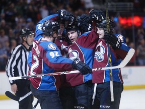Colorado Avalanche defenseman Andre Benoit (61) celebrates with teammates after scoring a goal with 11 seconds left in the second period against the Winnipeg Jets at Pepsi Center. Mandatory Credit: Chris Humphreys-USA TODAY Sports
