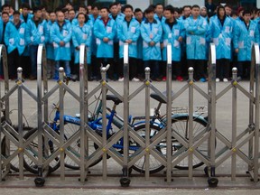 IBM workers protest at an IBM factory in Shenzhen, Guangdong province, March 7, 2014. REUTERS/Alex Lee