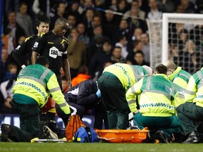 Bolton Wanderers players look on as medical staff attend to Fabrice Muamba after he collapsed on the pitch during their FA Cup quarterfinal soccer match against Tottenham Hotspur at White Hart Lane in London March 17, 2012. (REUTERS)