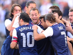 U.S. players celebrate with goalscorer Chris Wondolowksi (3rd R) after he scored early against South Korea during a pre-World Cup friendly match in Carson, California, on February 1, 2014. (AFP PHOTO/Frederic J. BROWN)