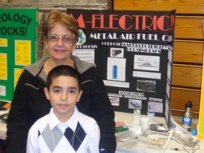 Kenny Cruz, 9, created a metal-air electrochemical cell at last year's Lambton County Science Fair, winning second overall. The Grade 4 student at High Park school, pictured here with his grandmother, Teresa Guerra, is returning with a different fuel cell experiment to this year's 41st annual competition. (Submitted photo)