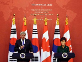 Canadian Prime Minister Stephen Harper (L) answers questions from reporters as South Korean President Park Geun-hye listens during a joint news conference after their meeting at the presidential Blue House in Seoul, March 11, 2014. REUTERS/Lee Jin-man/Pool