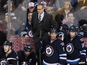 Head coach Paul Maurice of the Winnipeg Jets stands on the bench as he watches third-period action in an NHL game against the Ottawa Senators at the MTS Centre on March 8, 2014 in Winnipeg, Manitoba, Canada