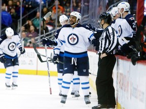 Winnipeg Jets defenseman Dustin Byfuglien (33) celebrates with teammates after scoring a goal during the second period against the Colorado Avalanche at Pepsi Center. Mandatory Credit: Chris Humphreys-USA TODAY Sports