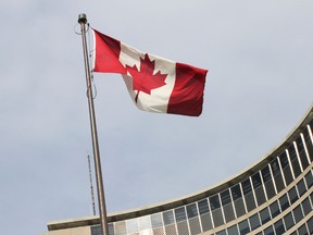 The Canadian flag flies in Nathan Phillips Square in front of Toronto City Hall Tuesday March 11, 2014. (Stan Behal/Toronto Sun)