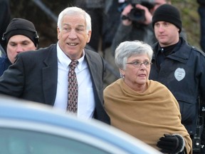 Former Penn State assistant football coach Jerry Sandusky (L) and his wife Dottie arrive for a preliminary hearing at the Centre County Courthouse in Bellefonte, Pennsylvania in this file photo taken December 13, 2011.  (REUTERS)