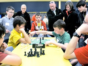 Lucas Piorro, left, contemplates his next move as opponent Zackary Lewis advances his chess piece during the 2013 Chatham Chess Challenge.