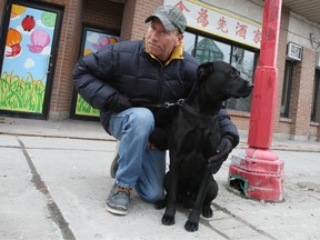 Marc Tardiff hopes the city shuts down and inspects the decorative light standards along Somerset St. West after his dog Midnight was shocked three times in four months, while out for a walk. Doug Hempstead/Ottawa Sun