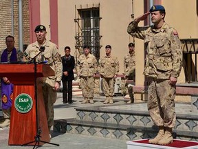 General Thomas Lawson, Chief of the Defence Staff, returns salute to Major General Dean Milner, last Commander of the Canadian Contribution to the Training Mission in Afghanistan (CCTM-A), during the flag lowering ceremony at the International Security Assistance Force headquarters on March 12, 2014, which marks the end of Canada's twelve-year military involvement in Afghanistan. (MCpl Patrick Blanchard? Canadian Forces Combat Camera/HANDOUT)