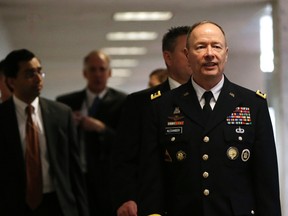 National Security Agency (NSA) Director General Keith Alexander (R) walks into a closed session of the Senate Intelligence Committee.

REUTERS/Gary Cameron