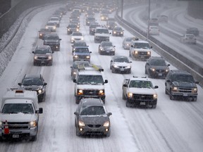 Traffic slowed to a crawl on the westbound Queensway during a late winter storm in Ottawa. March 12, 2014. Errol McGihon/Ottawa Sun/QMI Agency