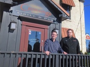 General Manager Paul Ouimet and Chef Dan Garlough stand in front of Crossings Pub and Eatery. Photo by Marlene Cornelis.