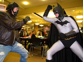 Bain and Batman face off during the fourth comic book jam at the London Public Library central branch on Wednesday. Bain, who?s actually Kevin Hodgret, of London, says he?s been a comic book fan his entire life. Batman, who insists that?s his actual name, was also among the many adults and children who dressed up as superheroes and villains Wednesday. (MIKE HENSEN, The London Free Press)