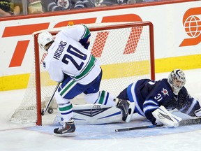 Canucks forward Chris Higgins scores on Jets goalie Ondrej Pavelec during their shootout at MTS Centre Wednesday. (BRUCE FEDYCK/USA TODAY Sports)