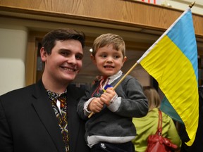 Myrolyub Bilash-Prystascz, 3, waves the Ukrainian flag. He and his father Mykola Bilash were part of 100's to attend a fundraising rally for those affected by the crisis in Ukraine at St. John's Cultural Centre in Edmonton on Wednesday, March 12, 2014. Doug Johnson/QMI Agency