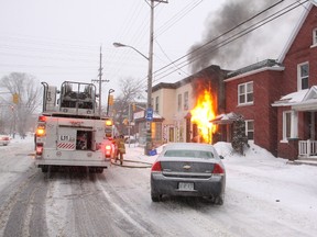 Fire crews set up their gear moments after arriving at a two-alarm fire at 504 Gladstone Ave. on Wednesday night. (SCOTT STILLBORN Ottawa Fire Service)