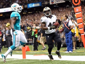 New Orleans Saints running back Darren Sproles carries the ball into the end zone for a touchdown in front of Miami Dolphins linebacker Jelani Jenkins in the second quarter at Mercedes-Benz Superdome. (Crystal LoGiudice/USA TODAY Sports)