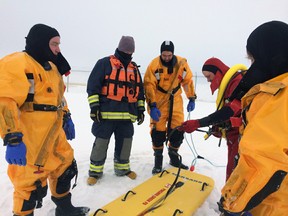 PCES members surround a special sled used to extract people who have fallen through the ice. Photo submitted.