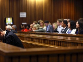 Olympic and Paralympic track star Oscar Pistorius reacts in the dock during his trial for the murder of his girlfriend Reeva Steenkamp, at the North Gauteng High Court in Pretoria March 13, 2014. (REUTERS/Themba Hadebe/Pool)