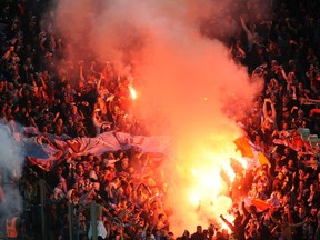 Trabzonspor's fans light flares during their Europa League round of 16 first leg match against Juventus at Juventus Stadium in Turin on Feb. 20, 2014. (Giorgio Perottino/Reuters)