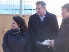 Ontario PC candidates Roxane Villeneuve-Robertson (Glengarry-Prescott-Russell) and Andrew Lister (Ottawa-Orléans) talk with the party's transportation critic Jeff Yurek on Thursday, March 13, 2014 at the Waller St. site where a sinkhole happened near the LRT east portal. JON WILLING/OTTAWA SUN