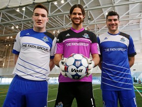 Albert Watson, left wears the new away jersey, goalie Lance Parker wears one of his two jerseys (the other one is yellow) and Frank Jonke the home jersey as FC Edmonton unveiled their fifth anniversary 2014 team kits Thursday. (Tom Braid, Edmonton Sun)