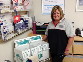 Cindy Nicholson, Manager of Postal Outlet at Cherryhill Village Mall. (CHIP MARTIN, The London Free Press)