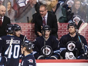 Head coach Paul Maurice of the Winnipeg Jets talks to his team from the bench during a break in third-period action in an NHL game against the Vancouver Canucksat the MTS Centre on March 12, 2014 in Winnipeg, Manitoba, Canada.