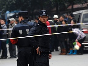 Police stand guard at a crime scene after a knifing incident in Changsha, Hunan province, March 14, 2014. (REUTERS/Stringer)