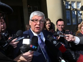 Dave Hancock speaks to the media after a caucus meeting at Government House in Edmonton, Alberta on Thursday, March 13, 2014.    Perry Mah/ Edmonton Sun/ QMI Agency