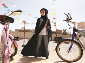 Wadjda (played by actress Waad Mohammed) examines bicycles in a screen shot from the self-titled film. cineSarnia will be screening "Wadjda" — the story of a young girl struggling with societal expectations and restrictions in Saudi Arabia — this Sunday and Monday. SUBMITTED PHOTO