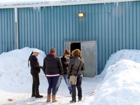 A group of people chat outside the band council chambers at the Whitedog First Nation community centre, before heading inside for the community-wide meeting to discuss accusations of corruption against the band council.