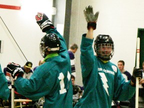 After a West Central District Lightning goal, there were high-fives all around by the players on the floor, including this one between Evan James (facing camera) and teammate Jackson Spiers during their win over Edmonton. - Gord Montgomery, Reporter/Examiner