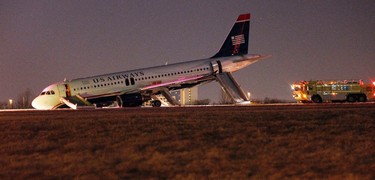 A U.S. Airways plane with a collapsed nose is seen at Philadelphia International Airport March 13, 2014. The plane with 149 people on board that was about to take off from Philadelphia International Airport had its nose gear collapse on the runway on Thursday, but no one was injured in the incident, an airport spokeswoman said.  REUTERS/Tom Mihalek