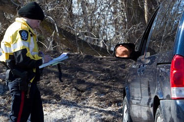A motorist reacts to getting a speeding ticket as members of the Edmonton Police Service take part in speed enforcement along Scona Road at 94 Avenue, in Edmonton, Alta., on Thursday March 13, 2014. David Bloom/Edmonton Sun/QMI Agency