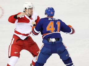 Edmonton Oilers forward Will Acton (41) fights Detroit Red Wings defenceman Brendan Smith (2) during the third period of an NHL game at Rexall Place in Edmonton, Alta., on Saturday, Nov. 2, 2013.  (Ian Kucerak/Edmonton Sun/QMI Agency)