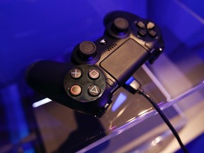 A controller of a PlayStation 4 is pictured at the Sony exhibition stand during the Gamescom 2013 fair in Cologne Aug. 21, 2013. REUTERS/Ina Fassbender