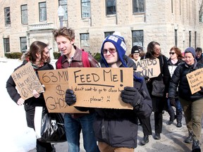 About 40 Queen's University students and staff walked through campus in Kingston on Friday March 14 2014 to protest the lack of transportation options, safety issues and food availability at the Isabel Bader Centre for the performing arts which is due to open in September.
IAN MACALPINE/KINGSTON WHIG-STANDARD/QMI AGENCY