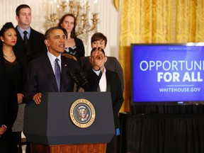 U.S. President Barack Obama talks before signing a Presidential Memorandum on modernizing the overtime system to help insure workers are paid fairly for their work while in the East Room of the White House in Washington, March 13, 2014. (REUTERS/Larry Downing)