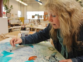 Karen Peperkorn has been teaching and sharing her love of art with students in the Creative Arts FOCUS program at Queen Elizabeth Collegiate since she started the program in 1990. Peperkorn works on a mixed medium piece in the Creative Arts studio at QECVI.
Julia McKay/Kingston Whig-Standard/QMI Agency