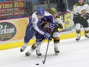 JOHN LAPPA/THE SUDBURY STAR/QMI AGENCY 
Matt Schmalz, left, of the Sudbury Wolves, and and a North Bay Battalion player battle for possession of the puck during OHL action at the Sudbury Community Arena on Friday night.