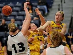 Queen's Golden Gaels Nicole Morse (13) and Jenny Wright battle for a rebound with the Saskatchewan Huskies' Dalyce Emmerson during a first-round game at the Canadian Interuniversity Sport women's basketball championship tournament in Windsor on Friday. The Huskies won 61-52. (Edwin Tam/University of Windsor)