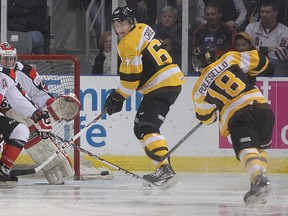 Kingston's Robert Polesello takes a shot on Ottawa goalie Philippe Trudeau as 67s' Taylor Fielding and Frontencs' Lawson Crouse look on during Friday night's game at the rogers K-Rock Centre. Michael Lea The Whig-Standard