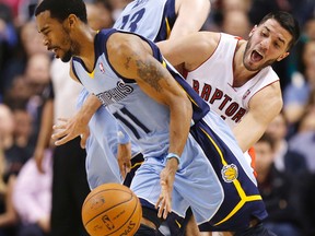 Grizzlies’ Mike Conley uses a pick to lose Raptors’ Greivis Vasquez at the ACC last night. Vasquez had 17 points in the win. (Craig Robertson/Toronto Sun)